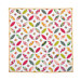 Flat image of of the local honey orange blossom throw quilt, consisting of a white background with overlapping circular designs made up of petal and diamond shapes, each made from different floral fabrics in pink, yellow, and green 