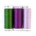 Three spools of thread in two shades of purple and green isolated on a white background