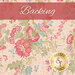 Warm toned cream fabric with pink, blue and gray flowers all over and green leaves with a pink banner at the top of the image with the work 