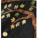 Close up photo of the Autumn Allure quilt showing applique tree and leaf details