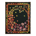 Photo of the Autumn Allure quilt made with black, purple, red, green, orange, and brown metallic fabrics isolated on a white background