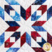 close up of block detail on the patriotic quilt made with batik fabrics in red, white, and blue in a starburst pattern