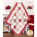 Photo of a red, pink, and cream quilt made with traditional style quilt star blocks and diamond blocks draped against a white paneled wall with white furniture and red and pink decor like a blanket, books, roses, and yarn.
