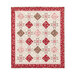 Photo of a red, pink, and cream quilt made with traditional style quilt star blocks and diamond blocks, isolated on a white background.