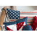 Close up of patriotic mini pillows in a wire basket with wooden handles