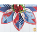 Leaf shaped table topper with central opening containing a floral centerpiece. Topper is made of red white and blue patriotic fabrics.