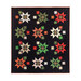 Photo of a black quilt with red, green, and cream star bursts isolated on a white background