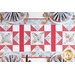 top down photos of a quilted table runner made with pink, blue and white floral fabrics with three sawtooth stars in a row and four place settings with matching cloth napkins at each corner