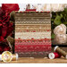 Earth tone and red fabric stacked on a wood table surrounded by roses and thread