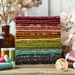 A photograph of the stack of fabrics included in the 28FQ set. The fabrics are staged with coordinating flowers and spools of threads.