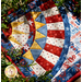 Photo of finished patriotic quilt square laying flat with greenery around the edges