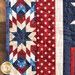 Close up of one edge of the Stars & Stripes 11 quilt showing stitching  and fabric detail