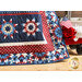 Close up of one corner of the Stars & Stripes 11 quilt showing detail with a small red wagon and patriotic decor in the background