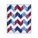A red, white and blue quilt with a large zig zag pattern isolated on a white background