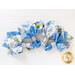 4 cloth napkins made of white, green, and blue floral prints fanned out with silver napkin holders on a white background