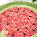 Close up of Watermelon Trivet showing batik fabric detail and seeds on a coiled mat