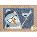 close up of a quilt block featuring a smiling snowman wearing a hat, scarf, and glasses with a bird perched on one raised stick arm with two star accents