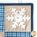 Close up of the top right corner block showing a white snowflake on a tan square