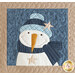 Close up of one block showing stitching detail and a smiling snowman wearing a hat and scarf and adorned with two stars on a dark blue background