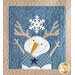 Close up of a quilt block featuring swirling stitches and a smiling snowman with their stick arms raised, wearing antlers and a plaid vest with a blue star. A large white snowflake is above, centered between the antlers.