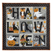 Photo of a small Halloween quilt hanging with each block of the quilt containing a letter of the word 