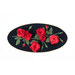 A black oval table topper with 3-dimensional roses and green leaves with gold beads around the edge isolated on a white background