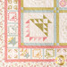 close up of one corner of a pastel floral quilt showing floral motifs and stitching detail