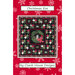 The front of the Christmas Eve Quilt pattern by Coach House Designs featuring a black Christmas quilt on a red background
