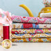 stack of fabrics included in Jubilee Mustard/Pink 5 fat quarter set