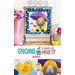 Photo of a finished wall hanging with a gnome dressed in a yellow raincoat and hat with an umbrella, a yellow bird in a puddle and a rainbow in the background hanging on a metal craft hanger with a basket of flowers, small bird statue, and flowers in a pink rain boot on either side and in front of a white paneled wall with the words 