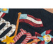 Close up of black wool mat showing applique detail of American flag and pinwheel in the center of the word 