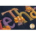 Close up of the Words in Wool November mat showing the applique detail of multicolored letters and a small turkey