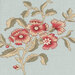 close-up of lovely gray-blue panel featuring tiles of dusty red flowers