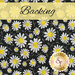 Black fabric with white daisies and swirls all over with a banner at the top that reads 