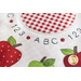 Close up photo of the applique detail in the Simply Sweet Table Topper - September showing fabric detail on red and green apples and a ring of letters and numbers at the center.