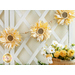 Photo of sunflower garland strung on a white trellis against a white wall with a brown and white farmhouse style countertop with yellow fabrics and a basket of yellow and white flowers