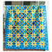 Image of a blue quilt with yellow ohio star piecing 