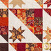 Close up photo of block in autumn-themed quilt made with Forest Frolic fabrics in a geometric pattern