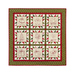 Photo of a Christmas themed quilt featuring 9 blocks with embroidered motifs isolated on a white background.