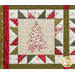 Close up of one quilt block showing fabric and stitching detail with an embroidered image of a Christmas tree