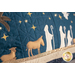 Close up photo of a large blue bench pillow embellished with decorative stitching in a nativity scene with twinkling lights