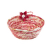 Photo of a bowl made from coiled red and cream colored fabrics with a red fabric flower isolated on a white background