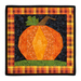 A square wall hanging featuring a pumpkin motif made with autumn themed fabrics, isolated on a white background