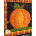 Close up of a square wall hanging featuring a pumpkin motif made with autumn themed fabrics