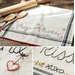 Collage of photos with close ups of a vintage style kitchen towel with heart embroidery and the phrase 