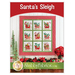 Front cover of the Santa's SLeight Quilt pattern showing a photo of the finished project hanging on a wall with Christmas decor all around, and designer information