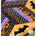 Close up photo of the Spooky Hallow table topper showing fabric details and bat motifs