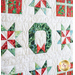 Close up of the center of the Happy Holidays quilt featuring a wreath and quilt stars all around