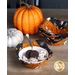 Photo of a place setting with a bowl filled with oreo ice cream and oreos inside the Hey Bootiful bowl cozy with small pumpkins and a stack of more bowl cozies in the background