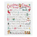 Image of a white cloth with the Christmas House Cookies pattern stitched into it featuring a recipe for cookies and holiday themed motifs